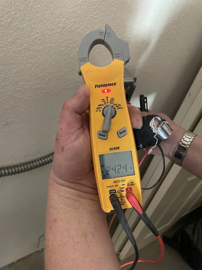 Voltage testing with clamp meter during Recessed Lighting Installation in Hurstbourne